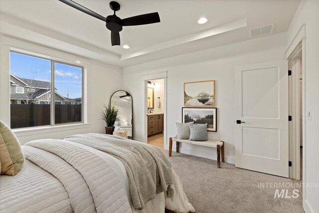 2316 E Valensole St, Meridian, ID 83642 - bedroom with light colored carpet, recessed lighting, a raised ceiling, connected bathroom, and a ceiling fan