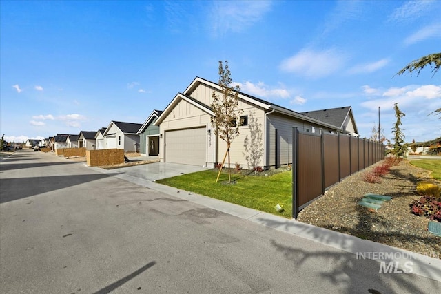 2316 E Valensole St, Meridian, ID 83642 - view of front of home featuring board and batten siding, concrete driveway, an attached garage, and a residential view