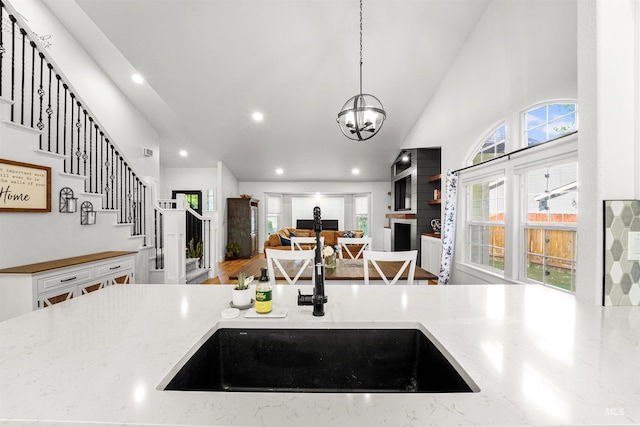 3832 W Aspen Creek Ct, Meridian, ID 83642 - kitchen featuring light stone countertops, hanging light fixtures, recessed lighting, a sink, and a chandelier