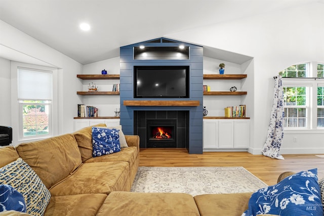 3832 W Aspen Creek Ct, Meridian, ID 83642 - living area with light wood-style floors, vaulted ceiling, a fireplace, and baseboards