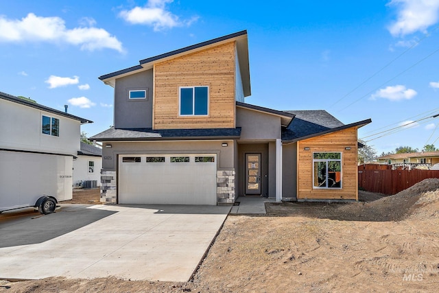 6825 W Ustick, Boise, ID 83704 - contemporary house featuring a garage, fence, stone siding, central AC unit, and driveway