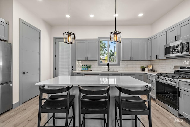 6825 W Ustick, Boise, ID 83704 - kitchen featuring light countertops, gray cabinets, stainless steel appliances, and light wood-style flooring