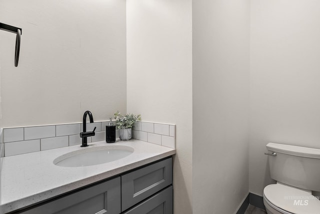 6825 W Ustick, Boise, ID 83704 - half bathroom with toilet, decorative backsplash, and vanity