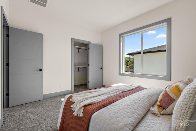 6825 W Ustick, Boise, ID 83704 - carpeted bedroom with visible vents, baseboards, a walk in closet, and a closet