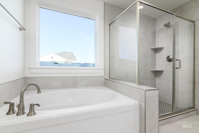 bathroom with separate shower and tub