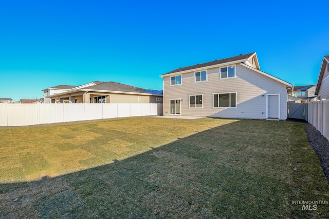 rear view of property featuring a lawn