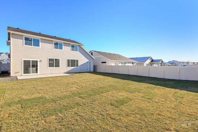 rear view of house with a yard