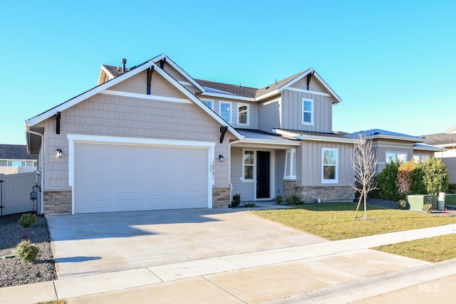 craftsman-style house featuring a front yard and a garage