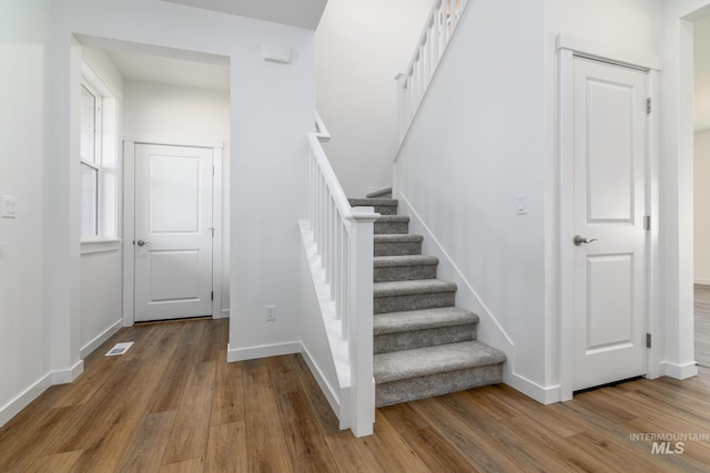 stairway featuring hardwood / wood-style floors