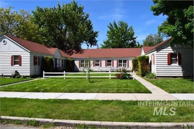 ranch-style home with a front lawn