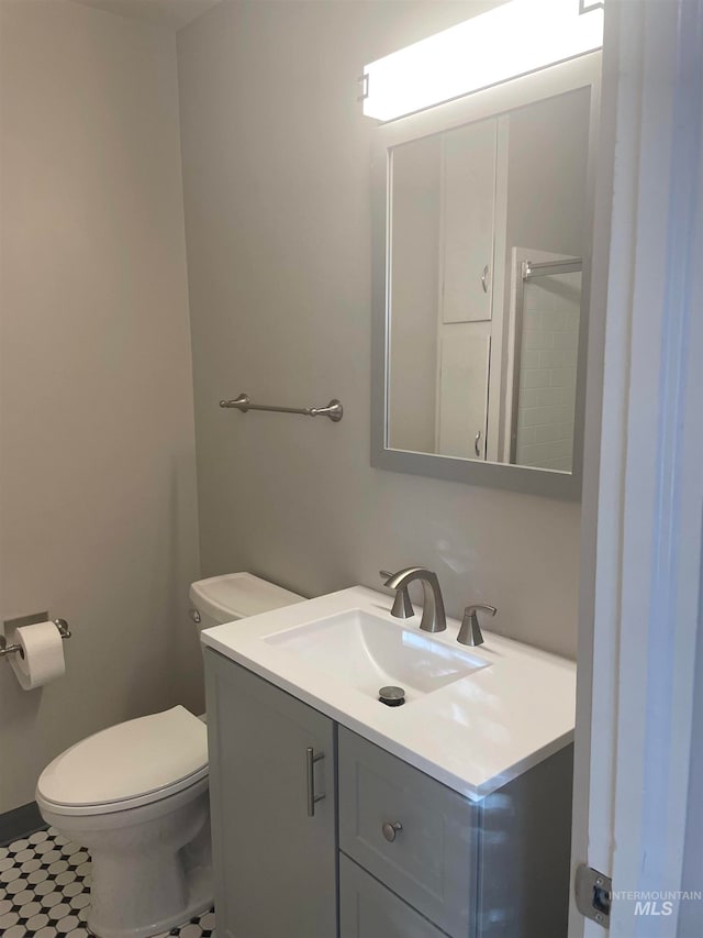 bathroom with tile patterned floors, vanity, and toilet