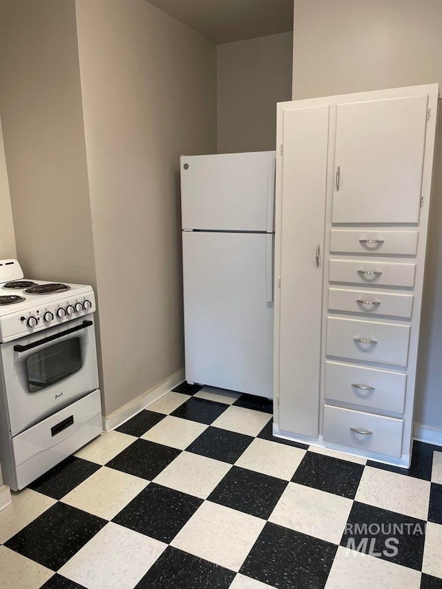 kitchen with white cabinetry and white appliances