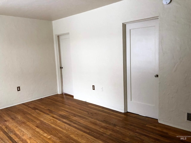 spare room with dark hardwood / wood-style floors