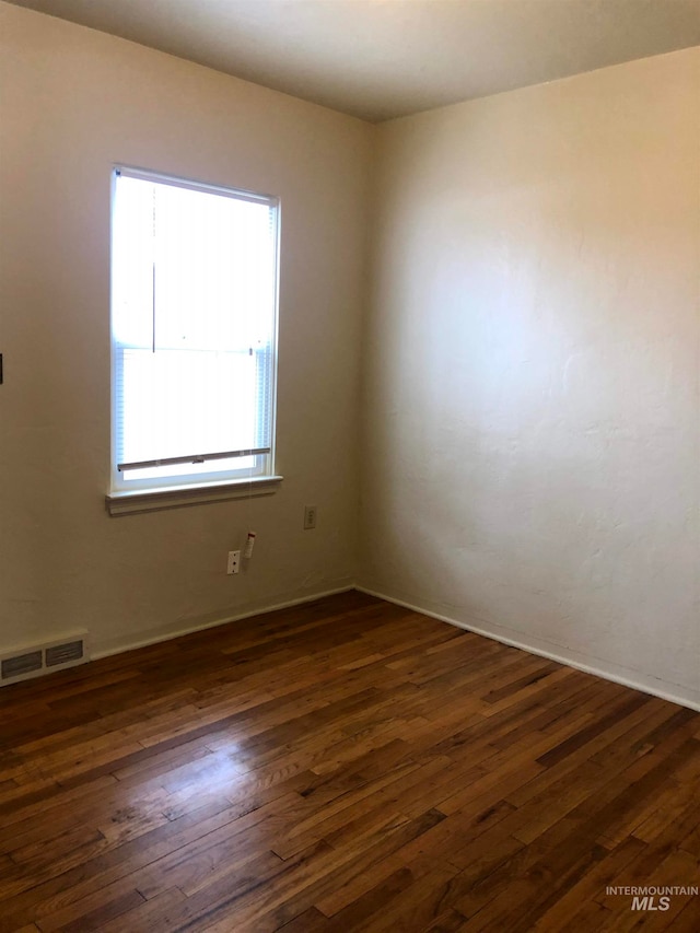 empty room featuring dark hardwood / wood-style floors