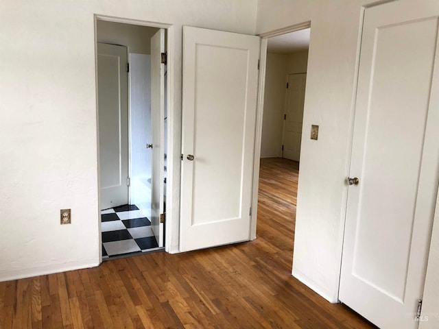 hallway with dark wood-type flooring