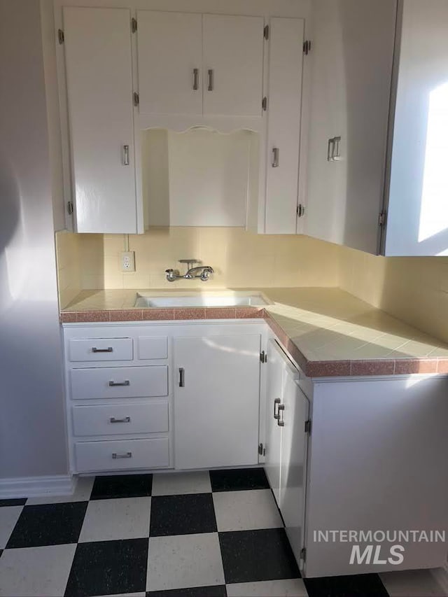 kitchen with white cabinets and sink