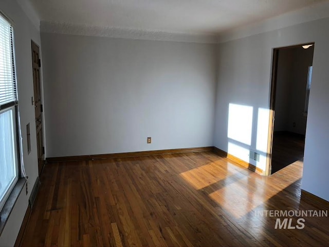 spare room with hardwood / wood-style floors