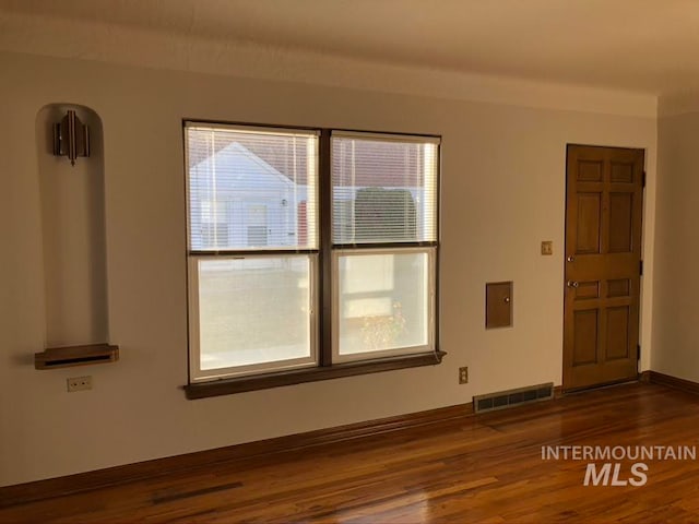 empty room with dark hardwood / wood-style flooring