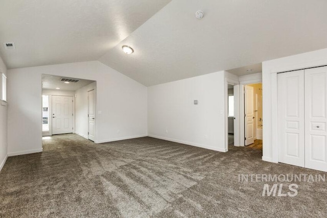 1116 N Peakhurt Ave, Kuna, ID 83634 - unfurnished living room featuring carpet and lofted ceiling