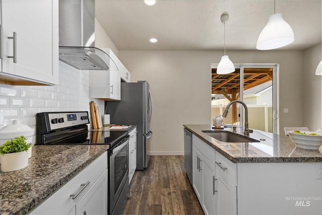 2089 W Claira Rd, Nampa, ID 83651 - kitchen featuring appliances with stainless steel finishes, range hood, dark wood-style flooring, decorative backsplash, and a kitchen island with sink