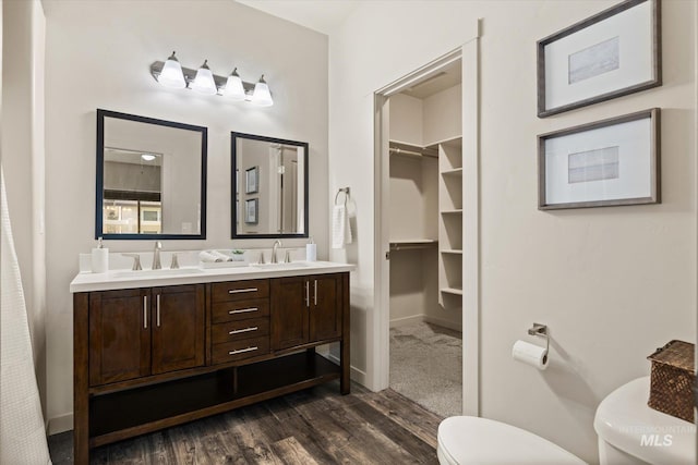 2089 W Claira Rd, Nampa, ID 83651 - bathroom featuring wood finished floors, double vanity, and a closet