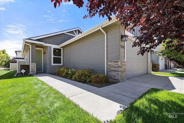 2089 W Claira Rd, Nampa, ID 83651 - ranch-style home with stone siding, a front lawn, concrete driveway, and a garage