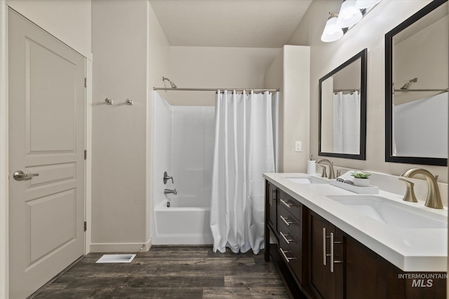 2089 W Claira Rd, Nampa, ID 83651 - full bathroom featuring double vanity, wood finished floors, and shower / tub combo