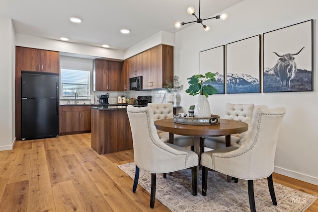 7439 W Swain Ln, Garden City, ID 83714 - dining space featuring baseboards, a notable chandelier, light wood-style floors, and recessed lighting