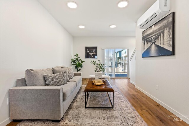 7439 W Swain Ln, Garden City, ID 83714 - living area with baseboards, a wall mounted AC, wood finished floors, and recessed lighting