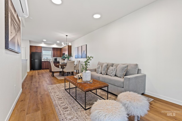 7439 W Swain Ln, Garden City, ID 83714 - living room with baseboards, an inviting chandelier, recessed lighting, and light wood-type flooring