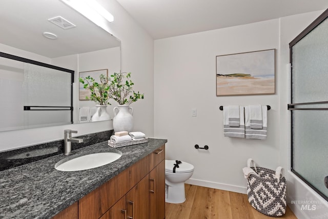 7439 W Swain Ln, Garden City, ID 83714 - bathroom featuring visible vents, baseboards, toilet, wood finished floors, and vanity