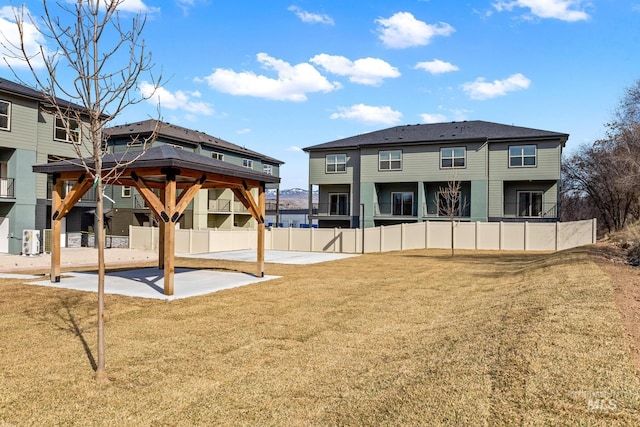 7439 W Swain Ln, Garden City, ID 83714 - rear view of property featuring a lawn, a gazebo, fence, and a patio