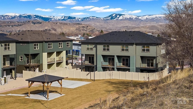 7439 W Swain Ln, Garden City, ID 83714 - rear view of property featuring a mountain view, fence, and a yard
