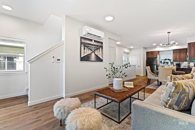 7439 W Swain Ln, Garden City, ID 83714 - living area with baseboards, a wall mounted AC, and light wood-style floors