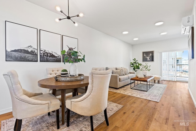 7439 W Swain Ln, Garden City, ID 83714 - dining space with light wood finished floors, baseboards, and a notable chandelier