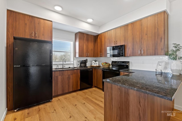 7439 W Swain Ln, Garden City, ID 83714 - kitchen featuring light wood-style flooring, brown cabinets, tasteful backsplash, a sink, and black appliances