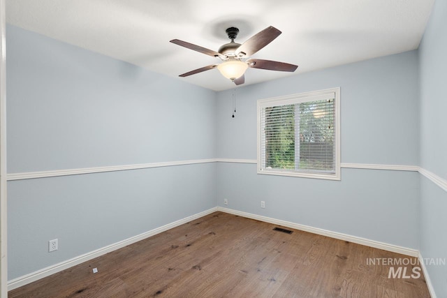 spare room with ceiling fan and hardwood / wood-style floors