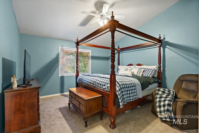 bedroom with light carpet, ceiling fan, lofted ceiling, and a textured ceiling