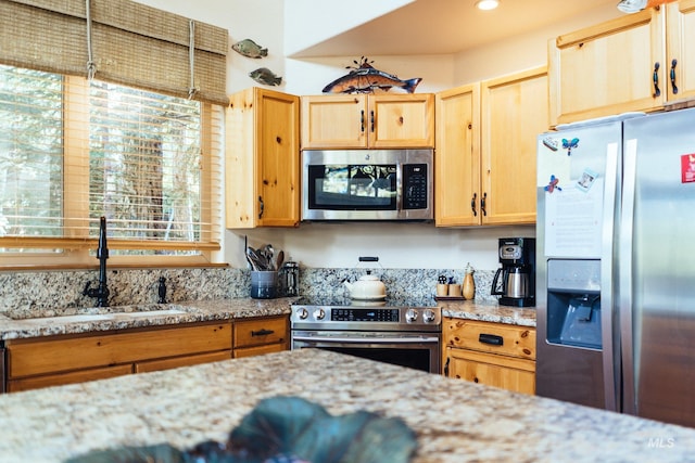 1013 Penstemen Pl, Mccall, ID 83638 - kitchen with appliances with stainless steel finishes, a sink, light stone counters, and light brown cabinetry