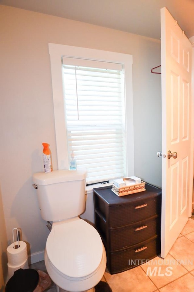 bathroom featuring toilet and tile patterned flooring