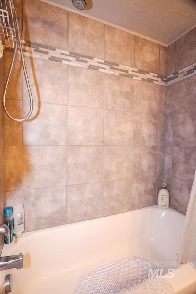 bathroom with shower / bathtub combination with curtain