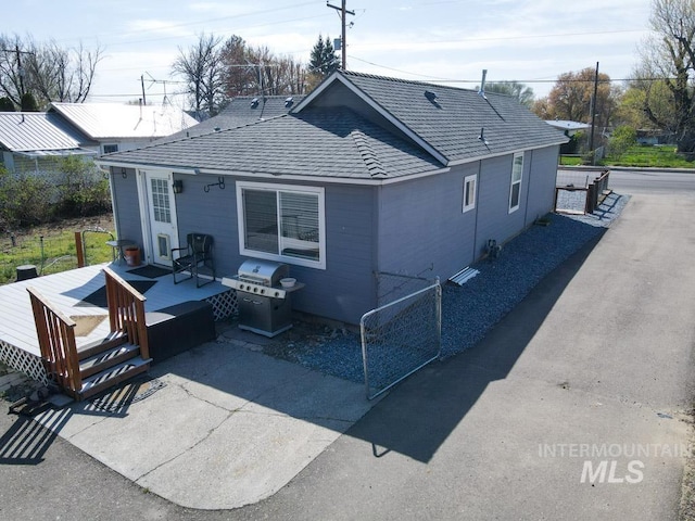rear view of house featuring a wooden deck