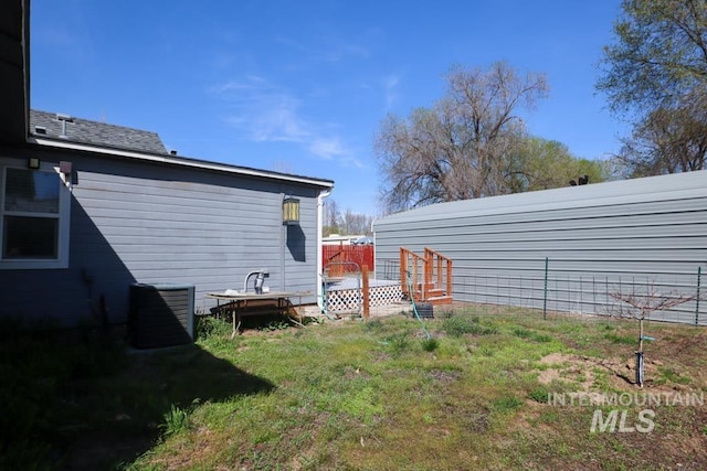 view of yard with a deck and fence