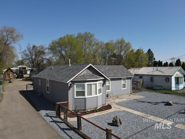 view of front of home featuring fence