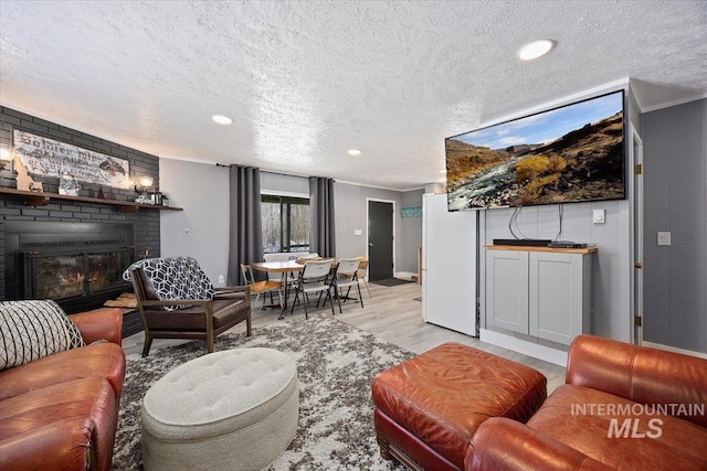 186 Phillips Creek Ln, Fairfield, ID 83327 - living room with a textured ceiling, light wood-type flooring, a fireplace, and recessed lighting