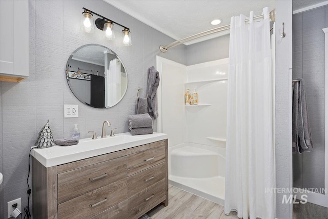 186 Phillips Creek Ln, Fairfield, ID 83327 - bathroom featuring wood finished floors, vanity, and a shower with shower curtain