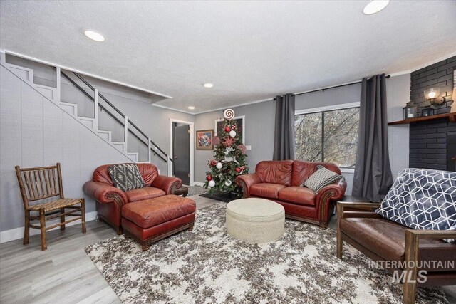 186 Phillips Creek Ln, Fairfield, ID 83327 - living area featuring light wood-style flooring, a textured ceiling, baseboards, stairs, and recessed lighting