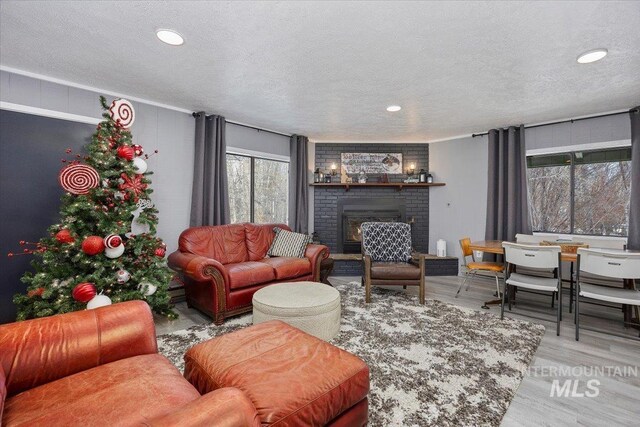 186 Phillips Creek Ln, Fairfield, ID 83327 - living room with a textured ceiling, a fireplace, wood finished floors, and recessed lighting