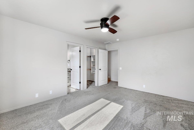 1022 S Date St, Jerome, ID 83338 - unfurnished bedroom featuring light carpet, a walk in closet, and a ceiling fan