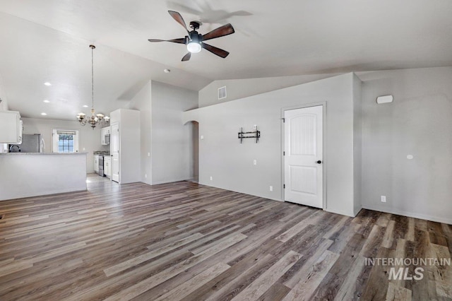 1022 S Date St, Jerome, ID 83338 - unfurnished living room with a chandelier, ceiling fan, lofted ceiling, and wood finished floors
